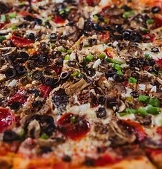 An everything pie loaded with sausage, mushroom, onion, green pepper and black olive